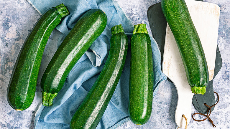 Raw zucchinis on table