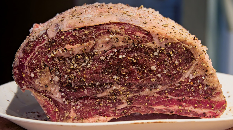 Prime rib covered in seasoning