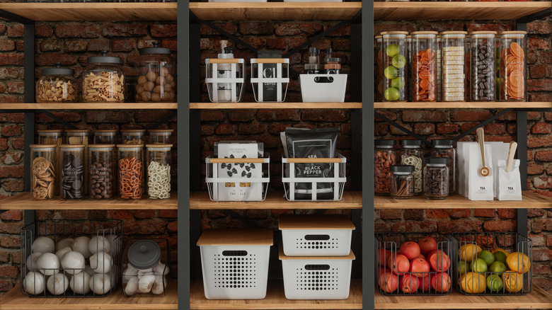 An organized pantry space with exposed brick