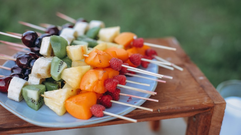 plate of mixed fruit kebabs