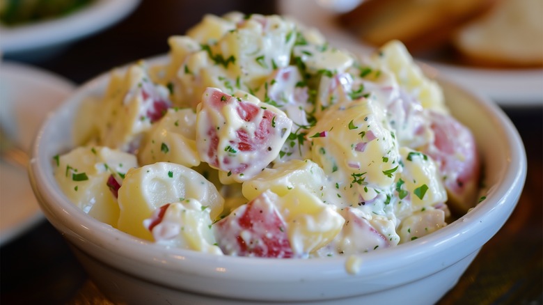 creamy potato salad in white bowl