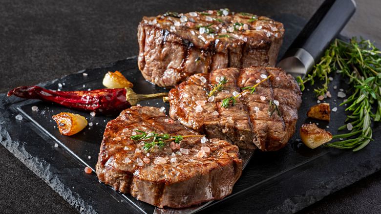 A plate of grilled steaks with butter