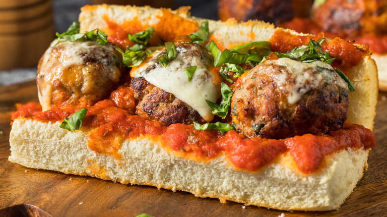 Meatball sub on cutting board