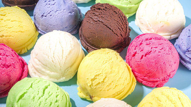 Many colorful single scoops of ice cream on a blue background