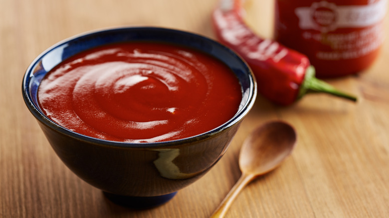 bowl and bottle of sriracha sauce