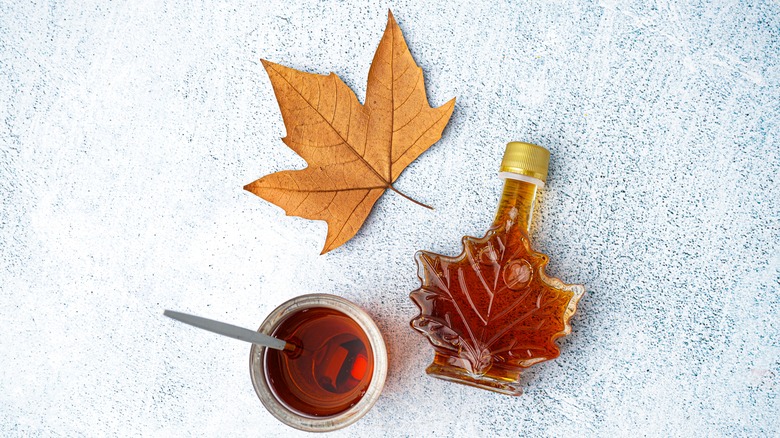 bowl of maple syrup and leaf