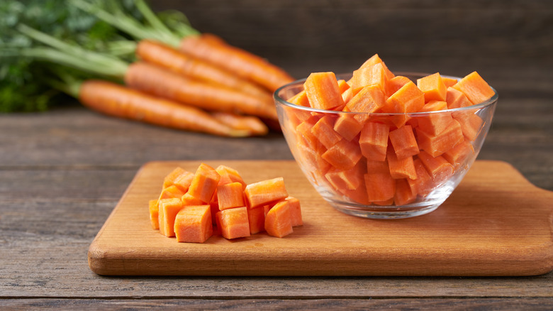 chopped carrots in bowl and on cutting board