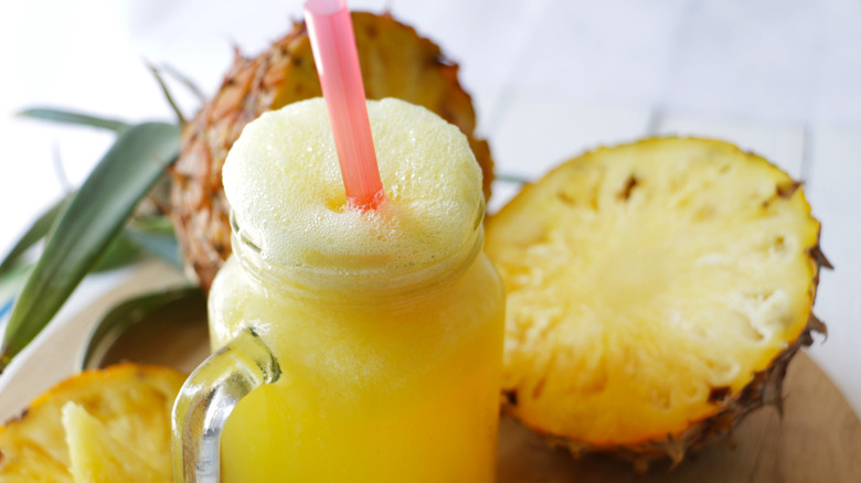 pineapple juice in mason jar with cut fruit