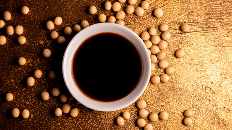 Soy sauce surrounded by soybeans