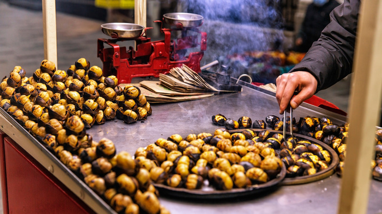 Roasted chestnuts in a street vendor cart