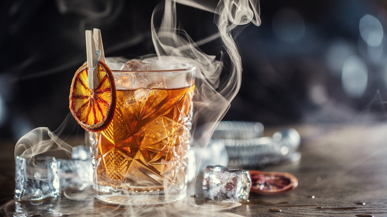 Old fashioned cocktail, ice, and smoke