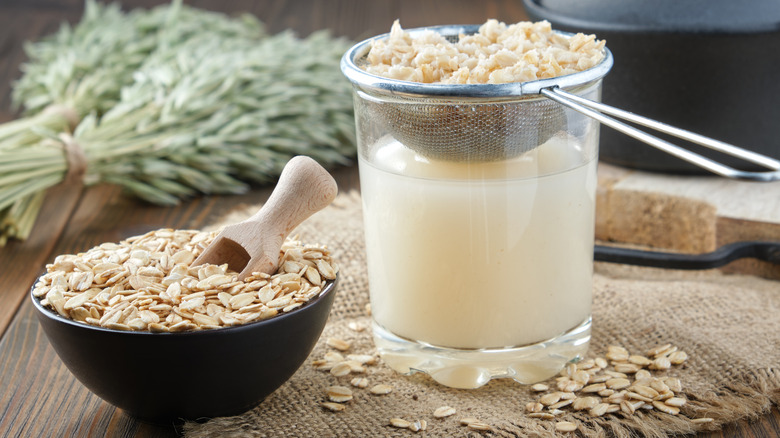 oats straining in a fine mesh strainer over a glass cup