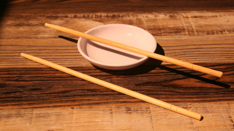 Chopsticks on table and dish