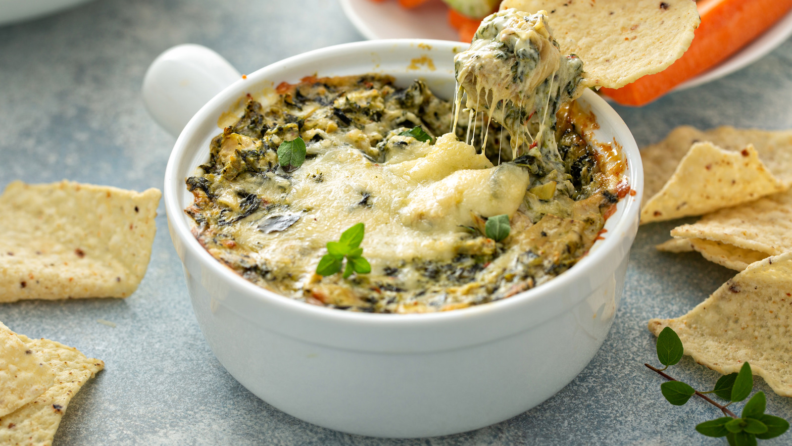 The Tangy Cheese To Liven Up Your Artichoke Dip