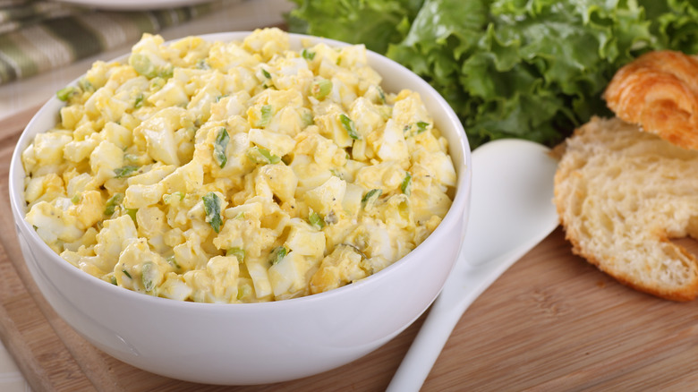 Bowl of egg salad with croissants 