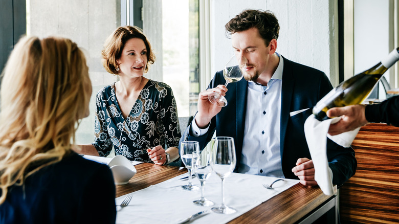 diner tasting wine in restaurant 