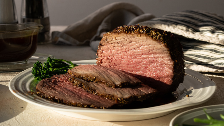 A cooked and sliced eye of round on a plate