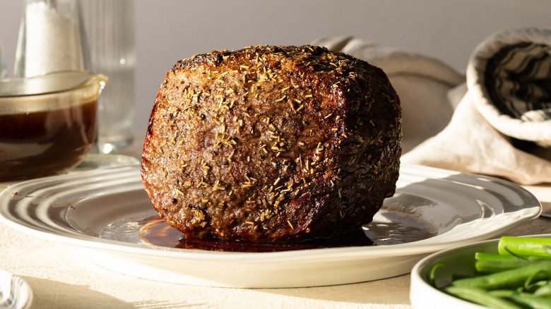 Herb-crusted eye of round on a plate