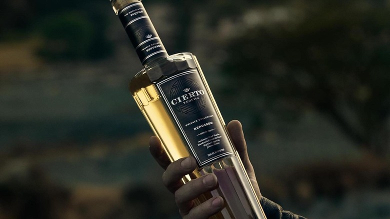 hand holding bottle of Cierto Tequila