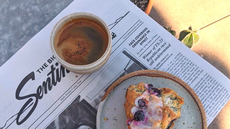 The Sentinel newspaper with coffee and pastry