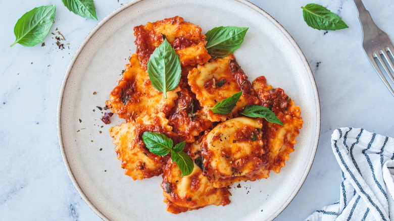 Ravioli with sauce and basil