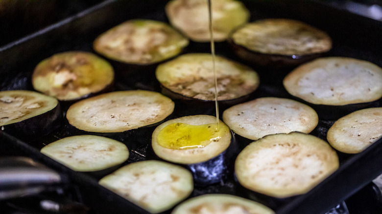 thick rounds of eggplant cooking