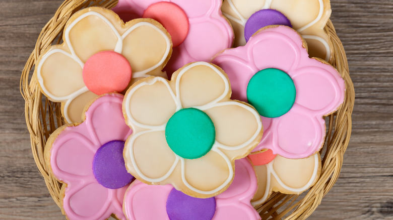 Basket of flower-shaped, iced sugar cookies