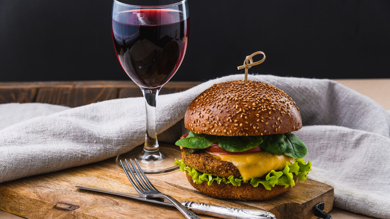 a burger and a glass of wine