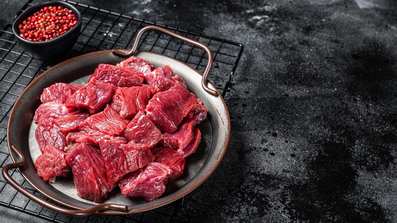 raw diced venison on pan