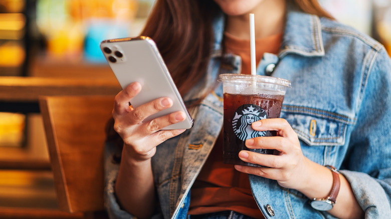 smartphone while drinking Starbucks