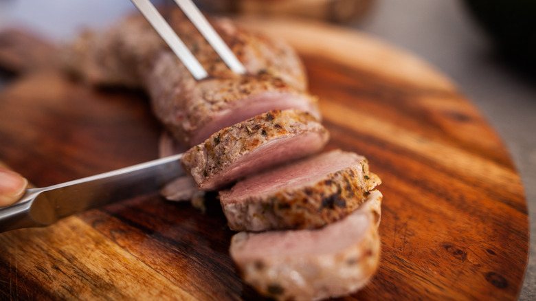 Sliced pork loin on cutting board