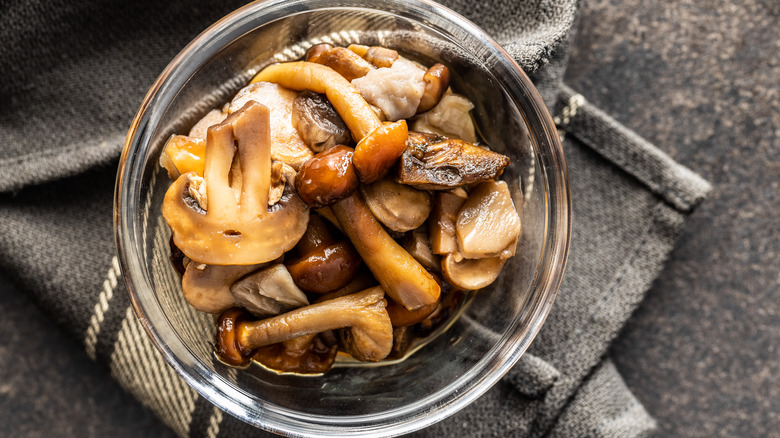 glass bowl of pickled mushrooms