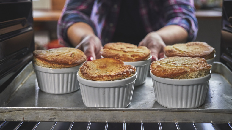 souffles cooking in oven in ramekins