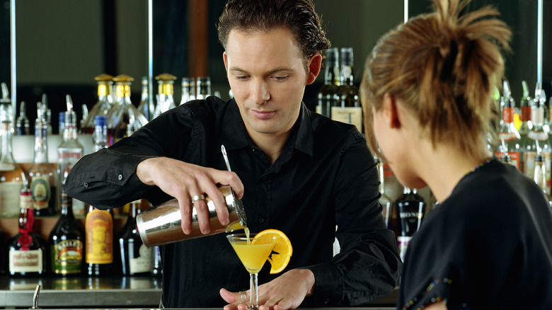 bartender pouring shaken sugary cocktail