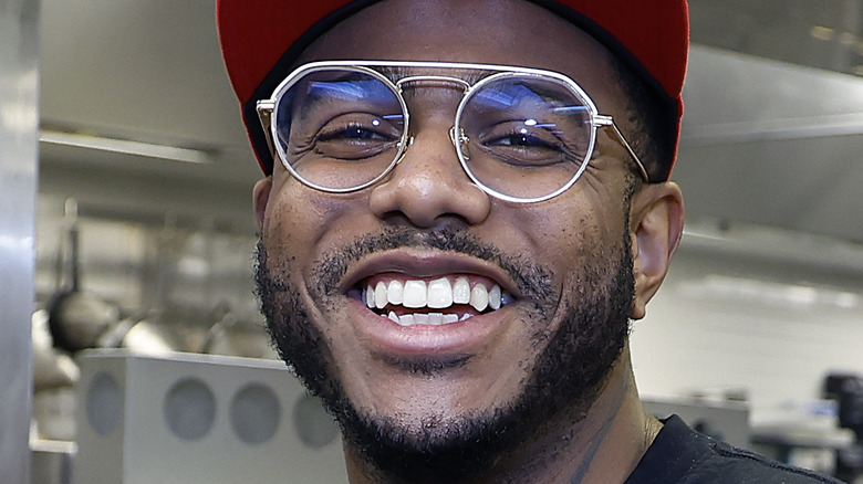 Kwame Onwuachi smiling in kitchen