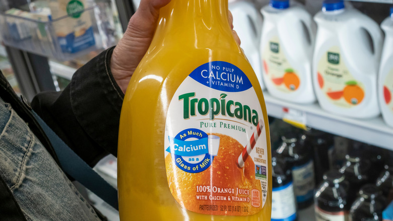 Someone holding a bottle of Tropicana orange juice