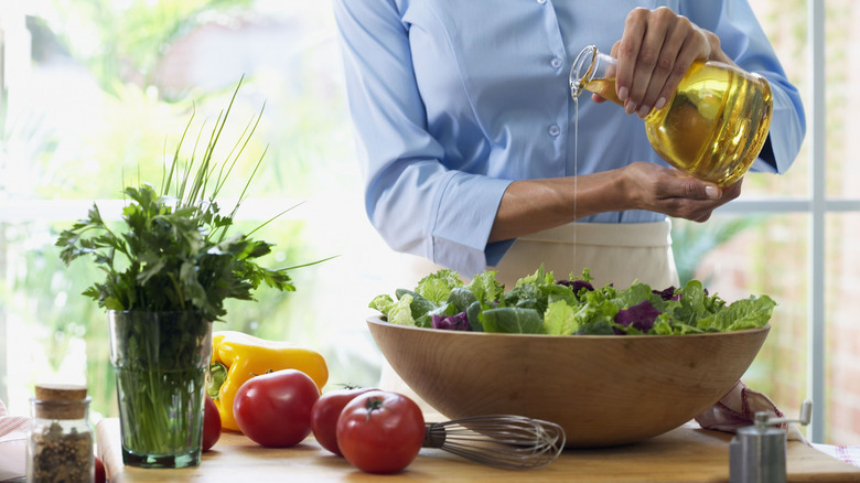 pouring dressing on salad