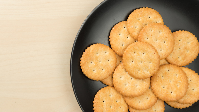 Ritz crackers on black plate