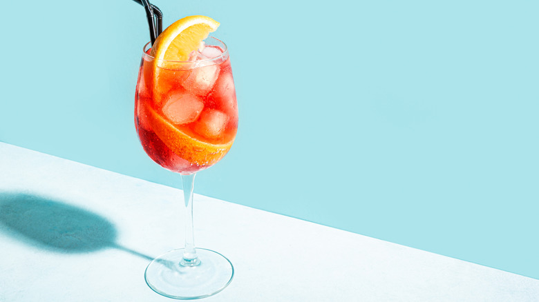 Aperol spritz with orange slice and straw