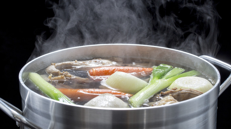 Pot of chicken broth steaming