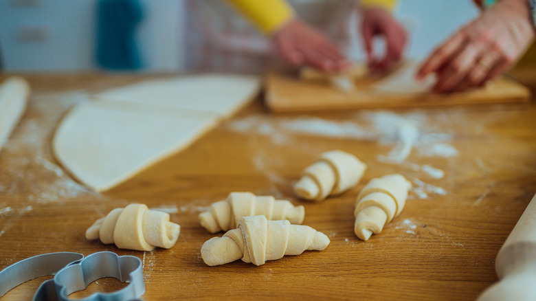 unbaked crescent rolls on wood