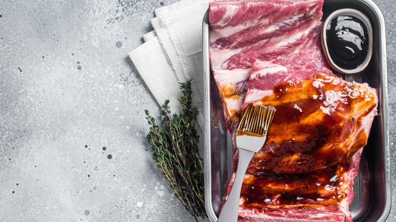 Marinating ribs with basting brush