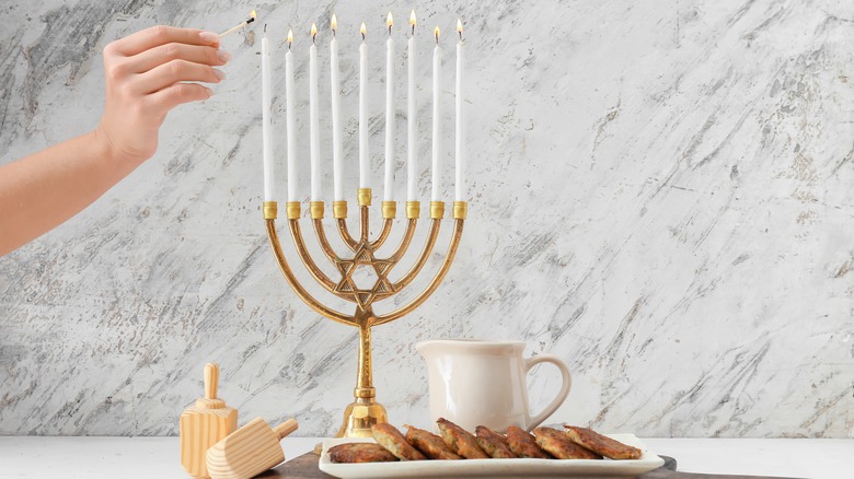 Lighting menorah and latkes