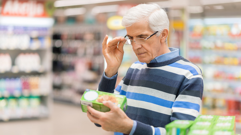 man reading label