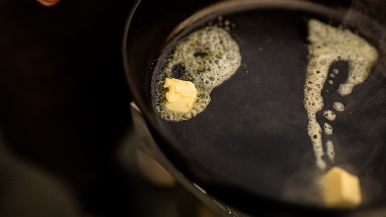 Butter melting in a cast iron pan