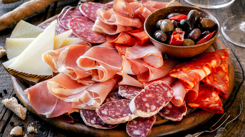 a charcuterie salumi board with different types of meats