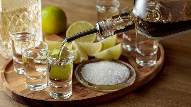 Tequila with lime slices on a tray