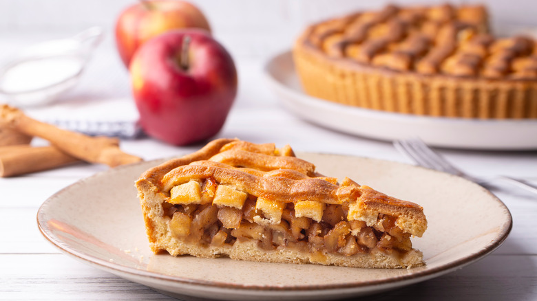 Apple lattice pie beside apples