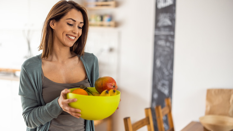 Woman holding fruit bowl