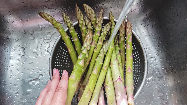 asparagus being rinsed